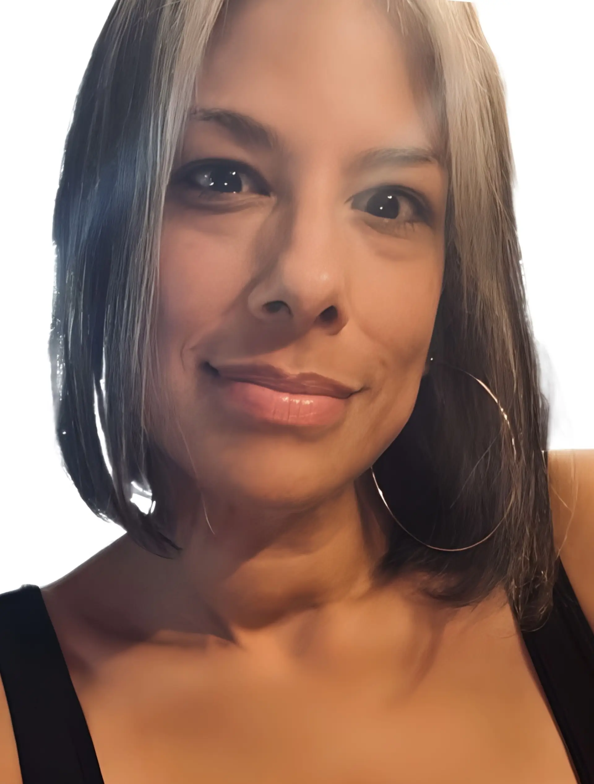 Close-up portrait of a woman with shoulder-length hair, hoop earrings, and a subtle smile.
